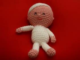 Muñeco de crochet con pijama y gorro blancos